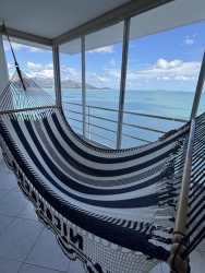Dining area with hammock by panoramic ocean windows in Playa Serena Coronado