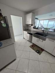 Spacious living room with sofa, floor-to-ceiling windows and Pacific Ocean views at Playa Serena Coronado