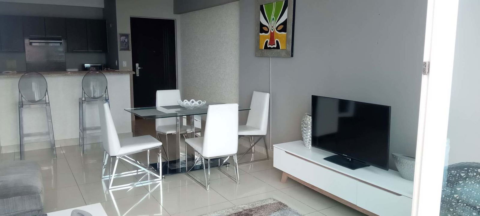 Modern open concept dining and living room with city view balcony PH Riverside Costa del Este Panama
