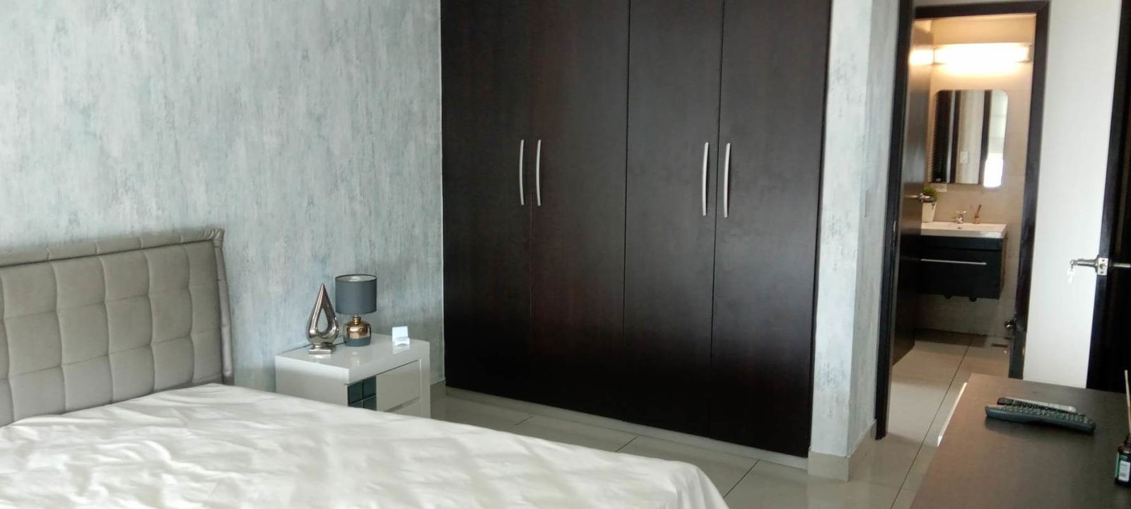 Modern furnished master bedroom with private balcony and en-suite bath at PH Riverside Costa del Este