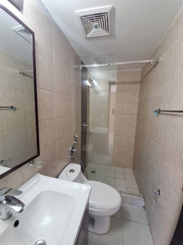 Bathroom with glass shower enclosure, beige tiles and modern fixtures in PH Carrasquilla Park View Panama City
