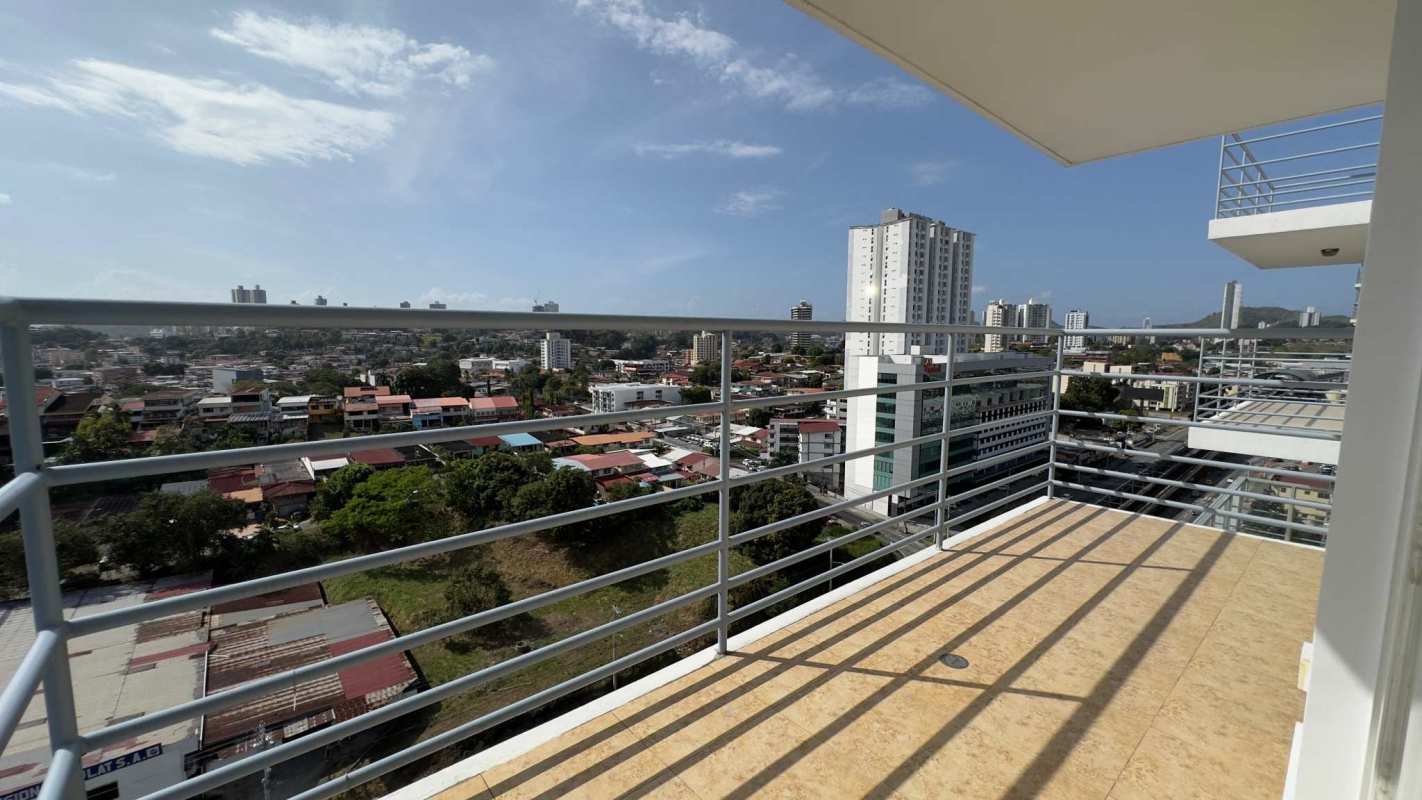 Dining room with glass-top table, black chairs, large windows and AC in Elevation Tower 12 de Octubre Panama