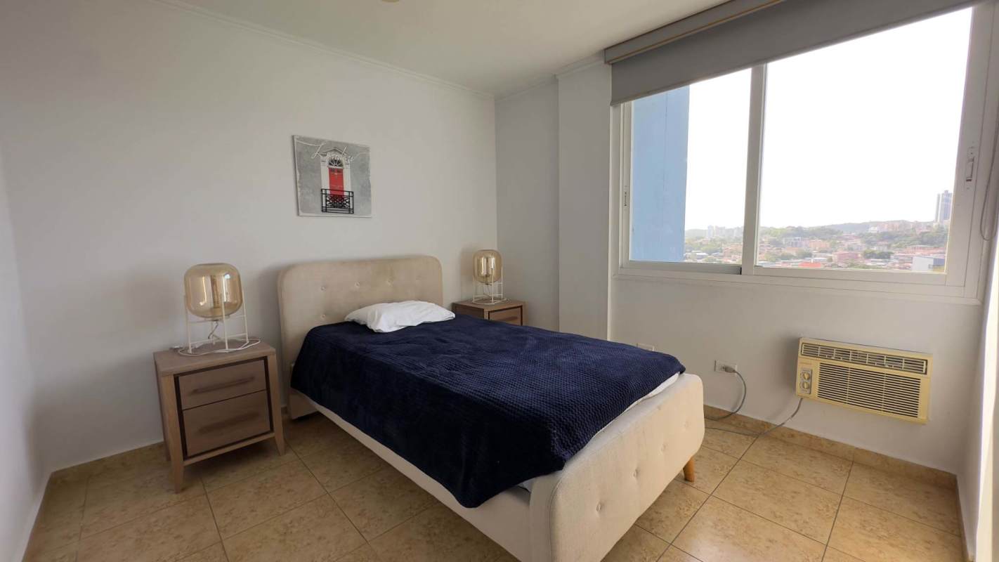 Minimalist bedroom with city view window and AC unit in Elevation Tower Panama