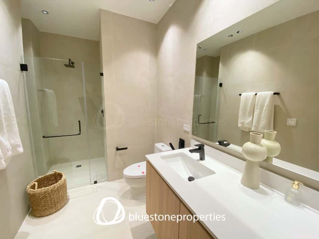 Contemporary bathroom with glass shower and quartz vanity at PH Oceana Santa María Panama