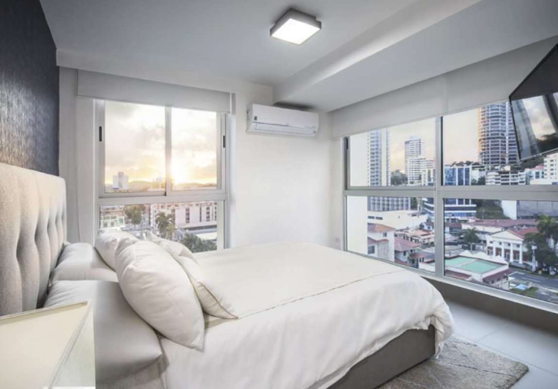 Contemporary open-plan living area with balcony access in Altamira Residences Bella Vista