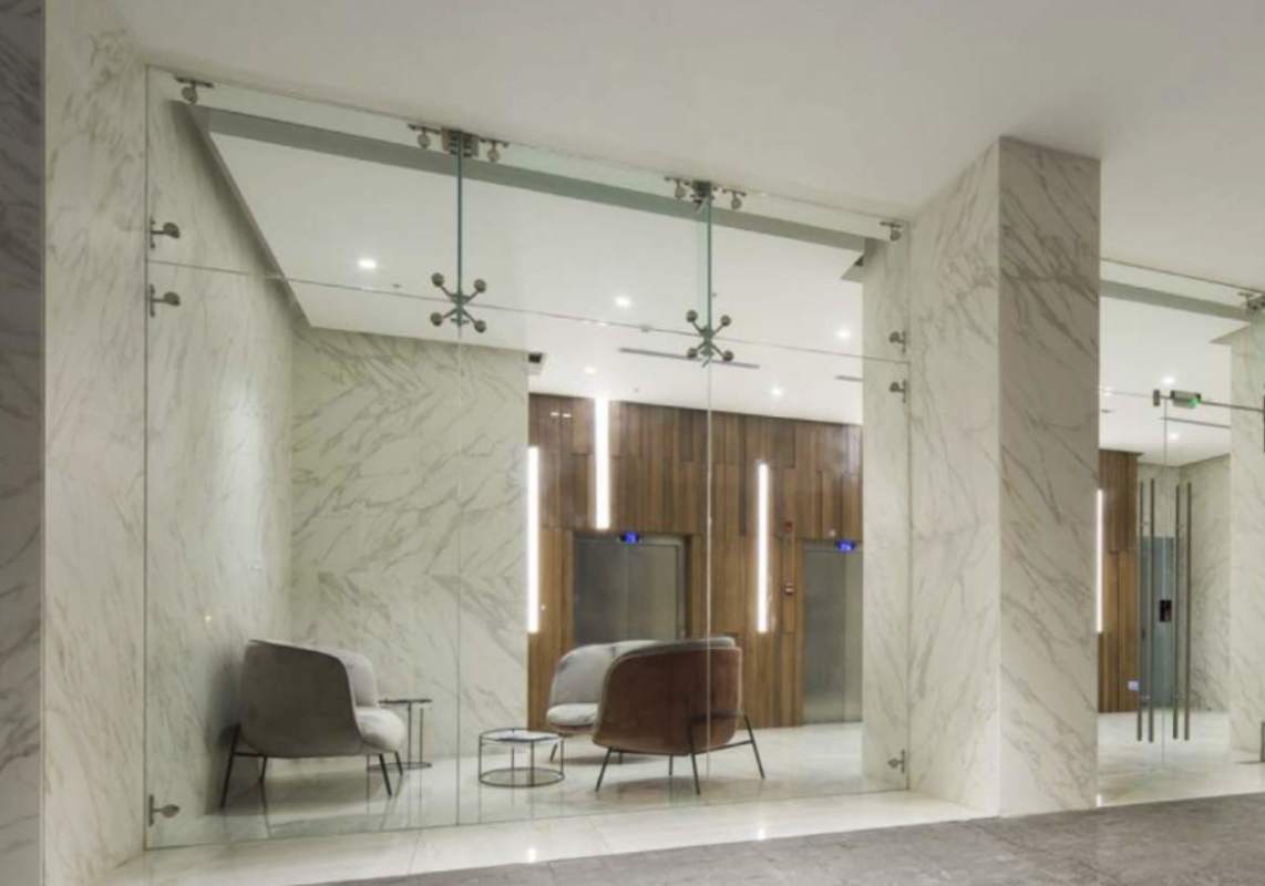 Contemporary lobby with marble and glass partitions, elevators in Altamira Residences Bella Vista Panama