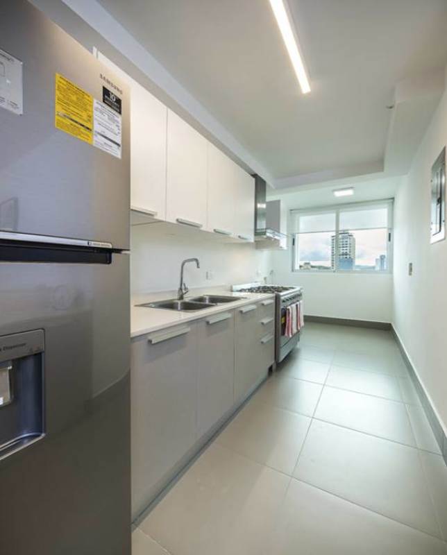 Colorful kid's playground on artificial grass rooftop with city view at Altamira Residences Panama City