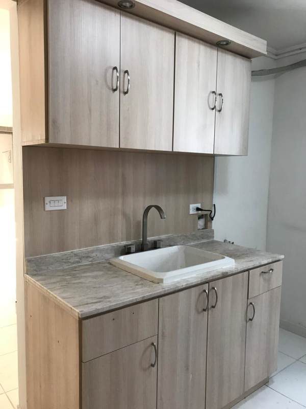 Compact kitchen with marble countertop, wood cabinets, tile backsplash in PH Rio Abajo Residences Panama