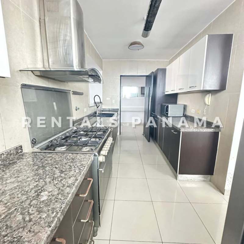 Spacious living room with glass doors opening to city view balcony in PH The Regent Panama