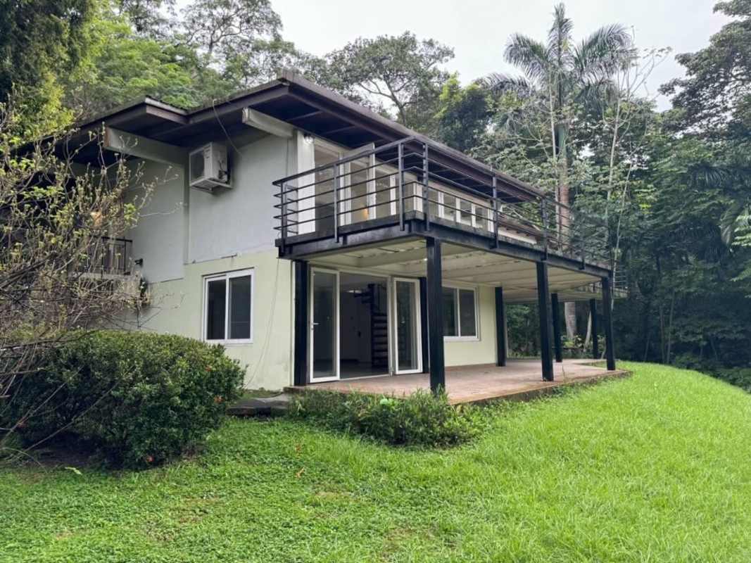 Modern living room with tiled floors, spiral staircase and access to terrace in Clayton Panama