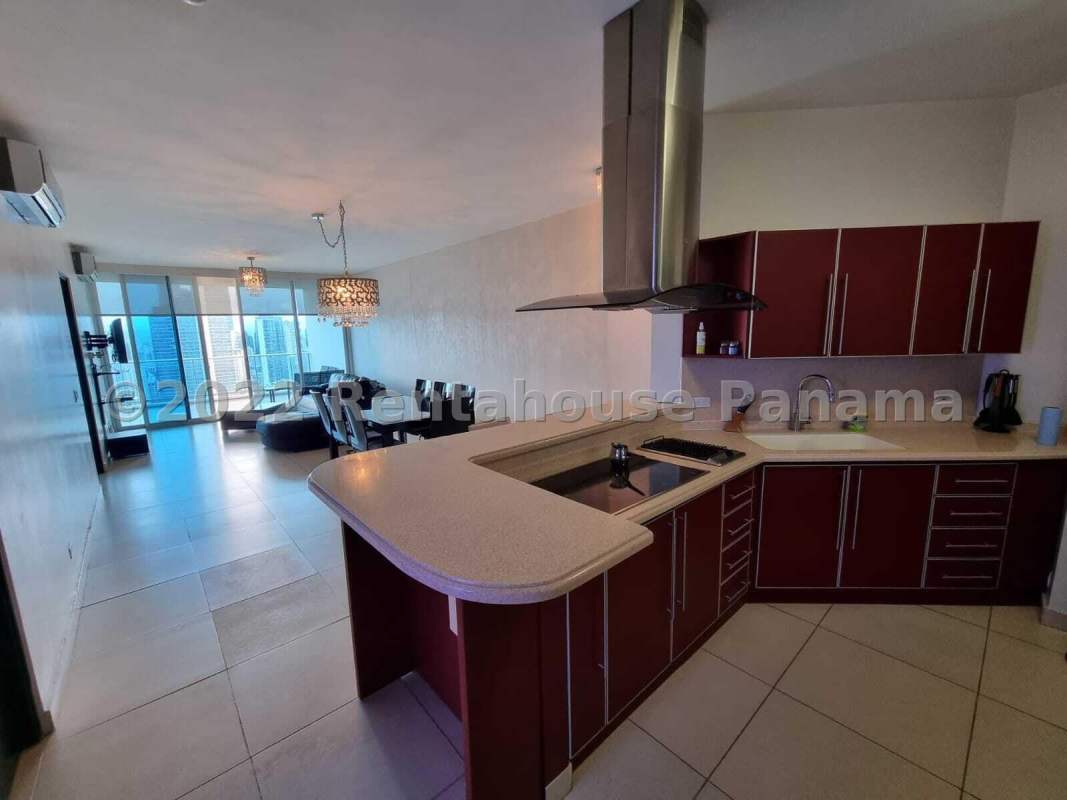 Modern integrated kitchen with granite counters and dining area in PH Destiny Tower apartment Panama City