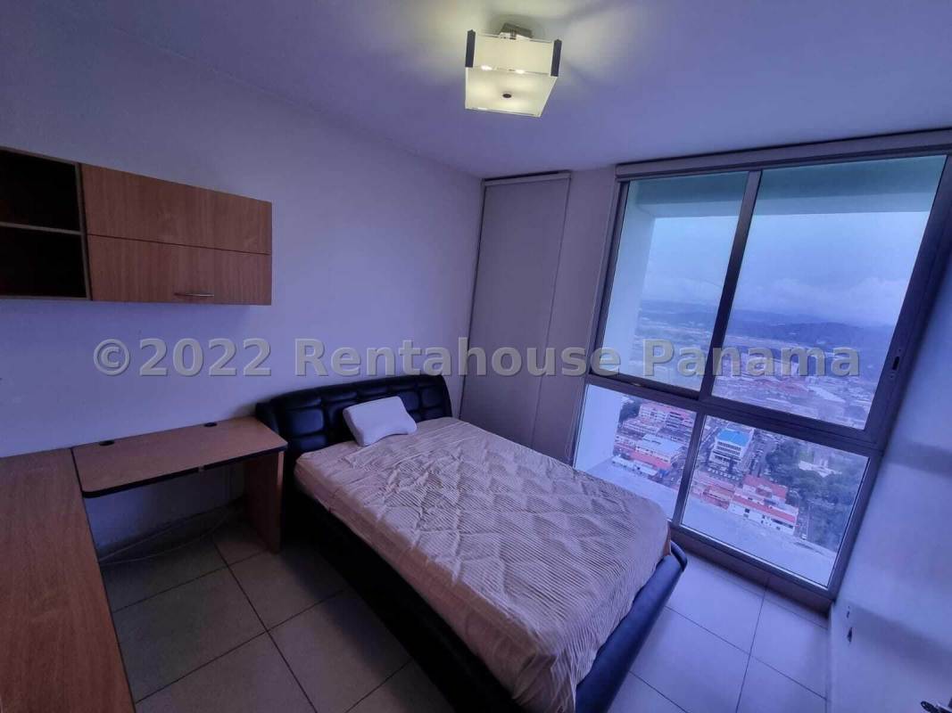 Modern furnished bedroom with large windows offering panoramic sea and skyline views at PH Destiny Tower Panama