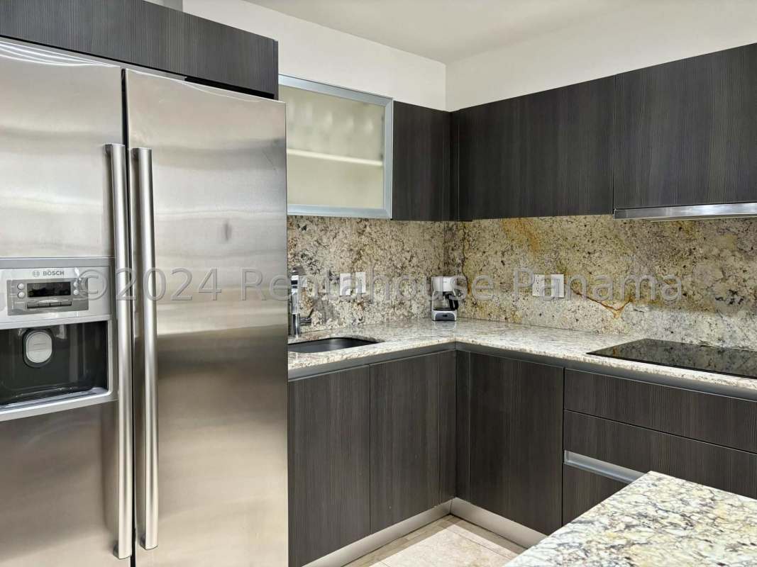 Open concept living-dining area with marble flooring and ocean view in Punta Pacifica apartment
