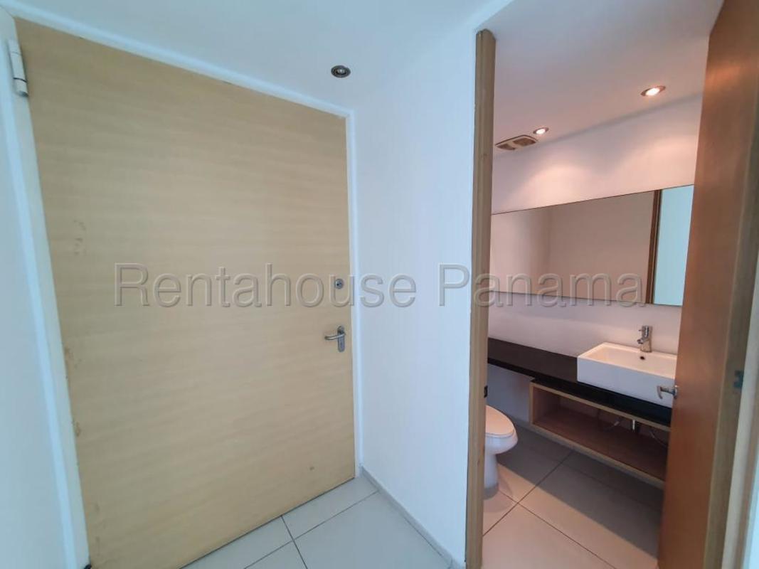Luxury bathroom with marble finishes, double sink and glass-enclosed shower at Pacific Point Costa del Este Panama