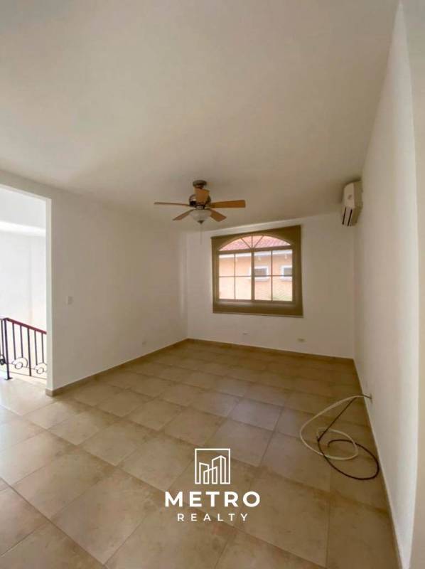 Large covered terrace with ceiling fan arched columns garden lawn Clayton Panama rental house