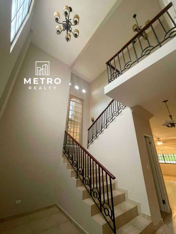 Spacious living room with beige tiles, large window, ceiling fans AC in luxury house Clayton Panama