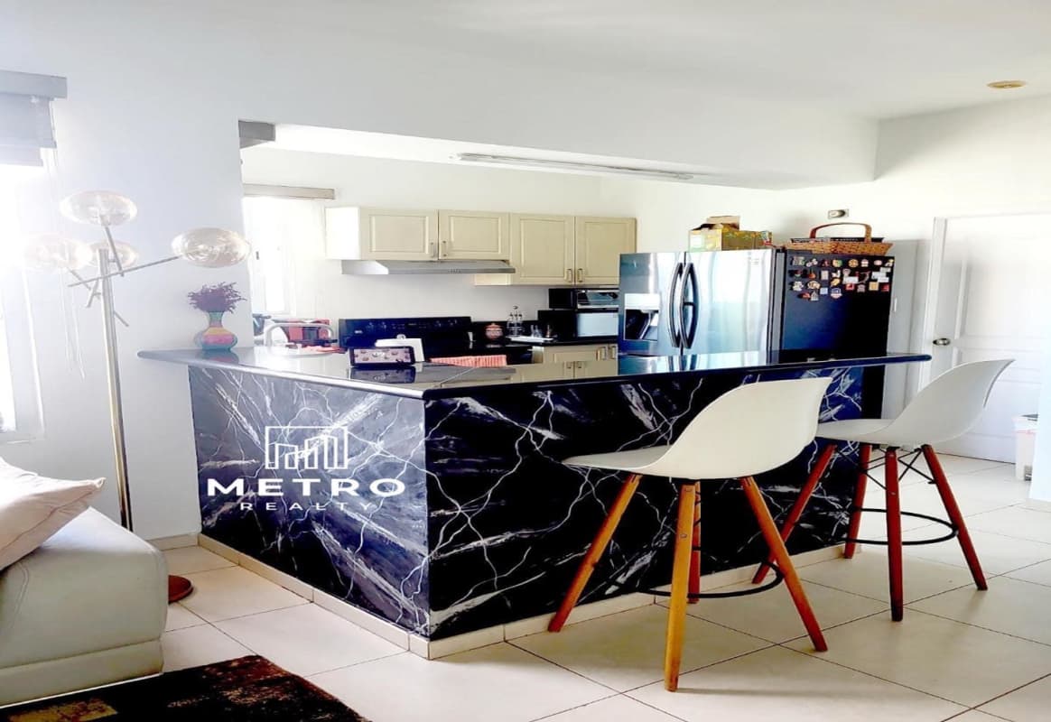 Contemporary open kitchen with breakfast island and views in PH Vista del Mar Panama City