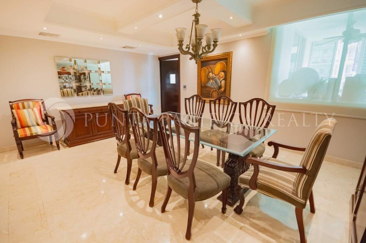 Large eclectic living room with sectional sofa, panoramic windows city view PH Bahia Esmeralda Panama