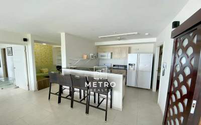 Open kitchen with granite countertop and breakfast bar in beachfront Coronado Bay condominium Panama