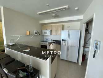 Spacious open kitchen with breakfast bar and living room in Coronado Bay condo Panama