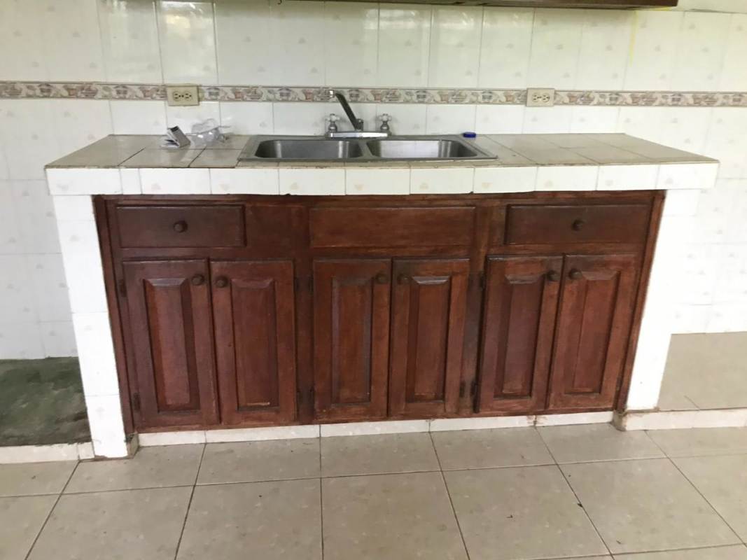 Facade of commercial residence with multiple doors, porch and garden Pedregal Panama