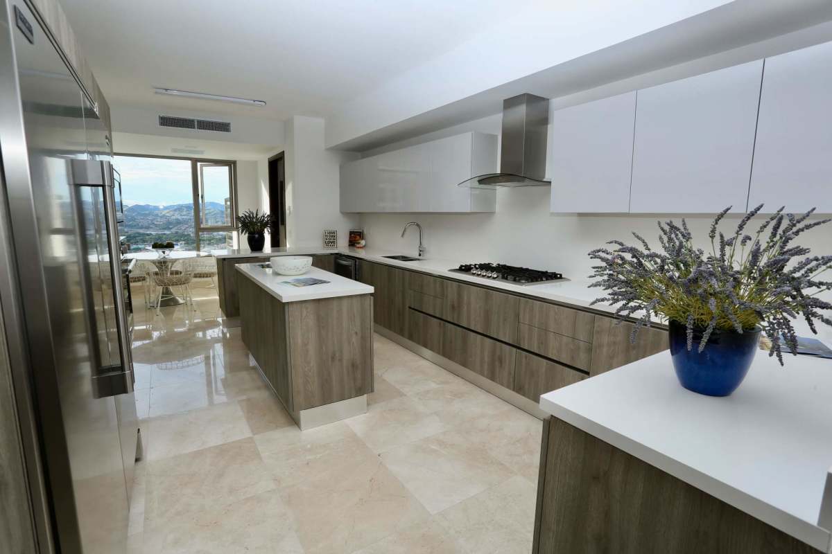 Luxury kitchen with island, modern cabinetry, large window mountain view in PH GreenGarden Santa María Panama City
