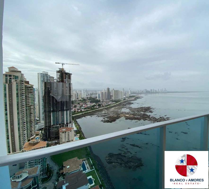 Living area with double height ceiling, floor-to-ceiling windows, ocean views Punta Pacifica Panama