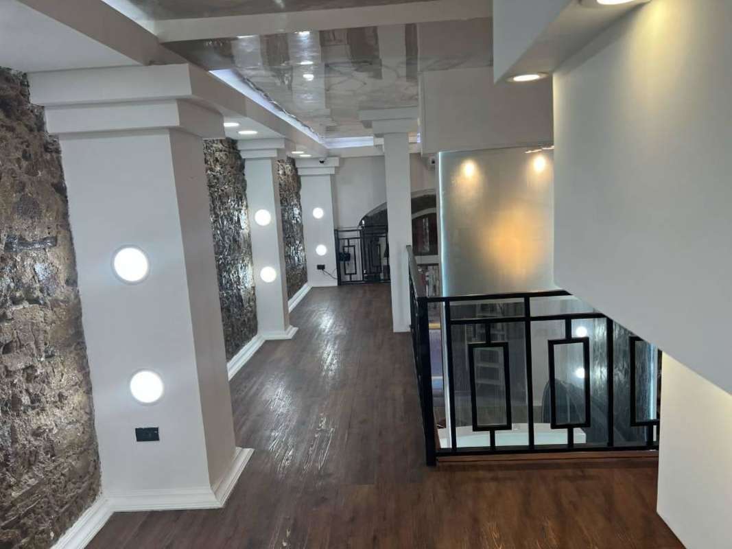 Interior hallway and loft area with stone walls, wood floors in historic Casco Viejo rental