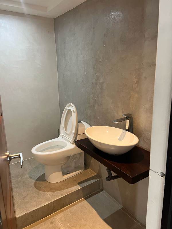 Contemporary bathroom with vessel sink, floating counter and stone wall Casco Viejo Panama