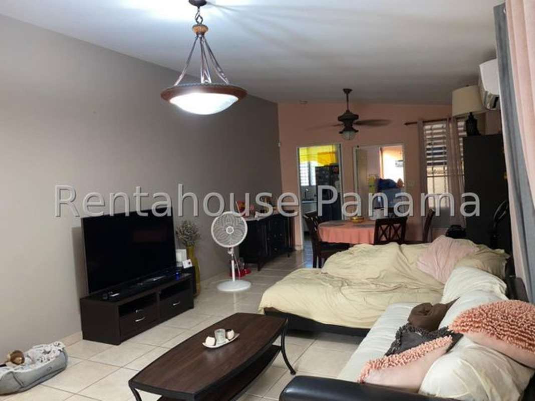 Spacious bright living and dining room with tile flooring and ceiling fans in family home Brisas del Golf Panama City