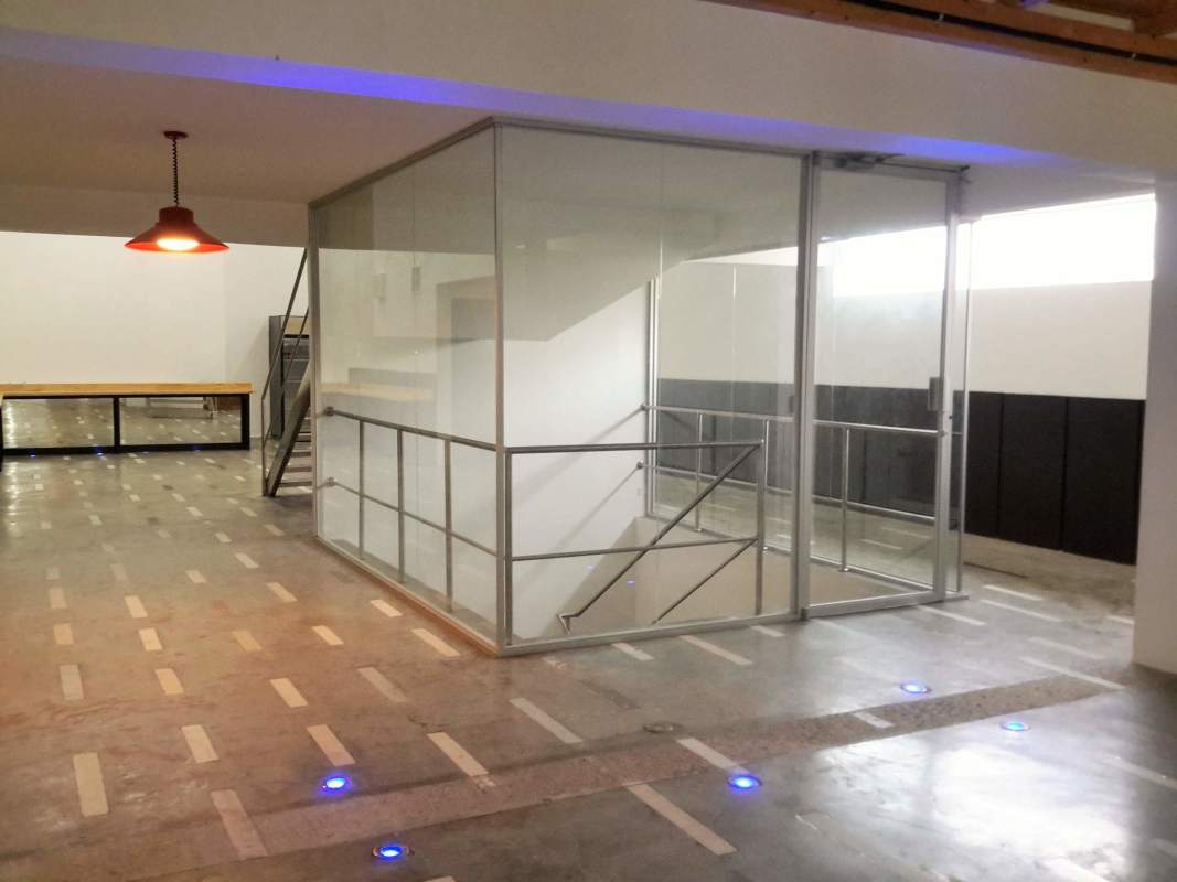 Elevator lobby with glass elevator doors and polished concrete floors in business building Panama City