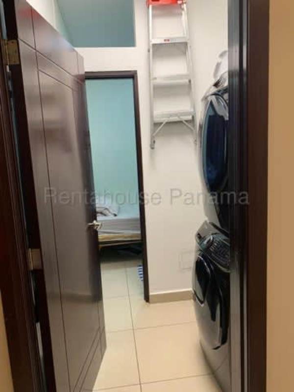 Private balcony with glass railing offering ocean and skyline views at PH Rivage Tower Panama City