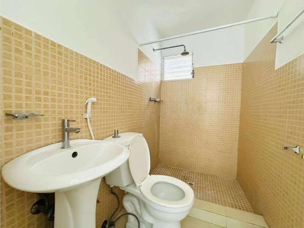 Bathroom with beige tiles, pedestal sink and bidet sprayer, PH T7 Panama City