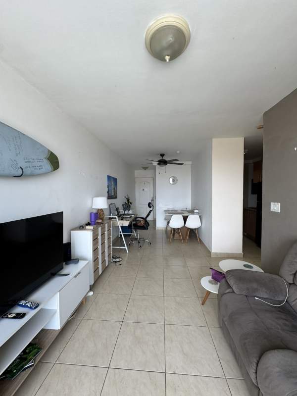 Private balcony with wicker chairs, glass railing and city views in PH Albrook Point Albrook Panama