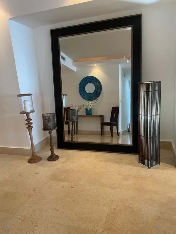 Open kitchen with modern finishes, stainless appliances and breakfast bar in luxury Yoo Panama apartment