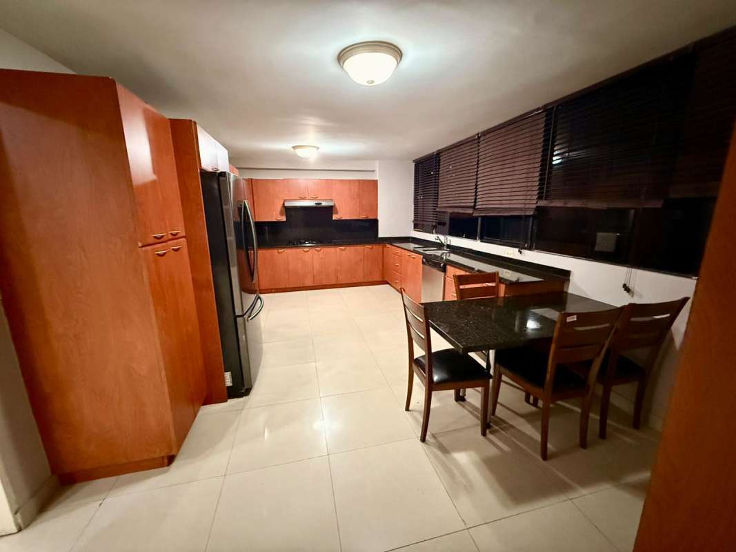 Sunlit living and dining room with access to balcony at PH Bella Vista Panama