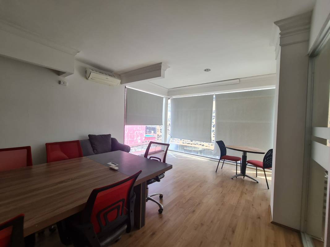 Office meeting space with large windows, wood flooring, light bright workspace in Obarrio Panama