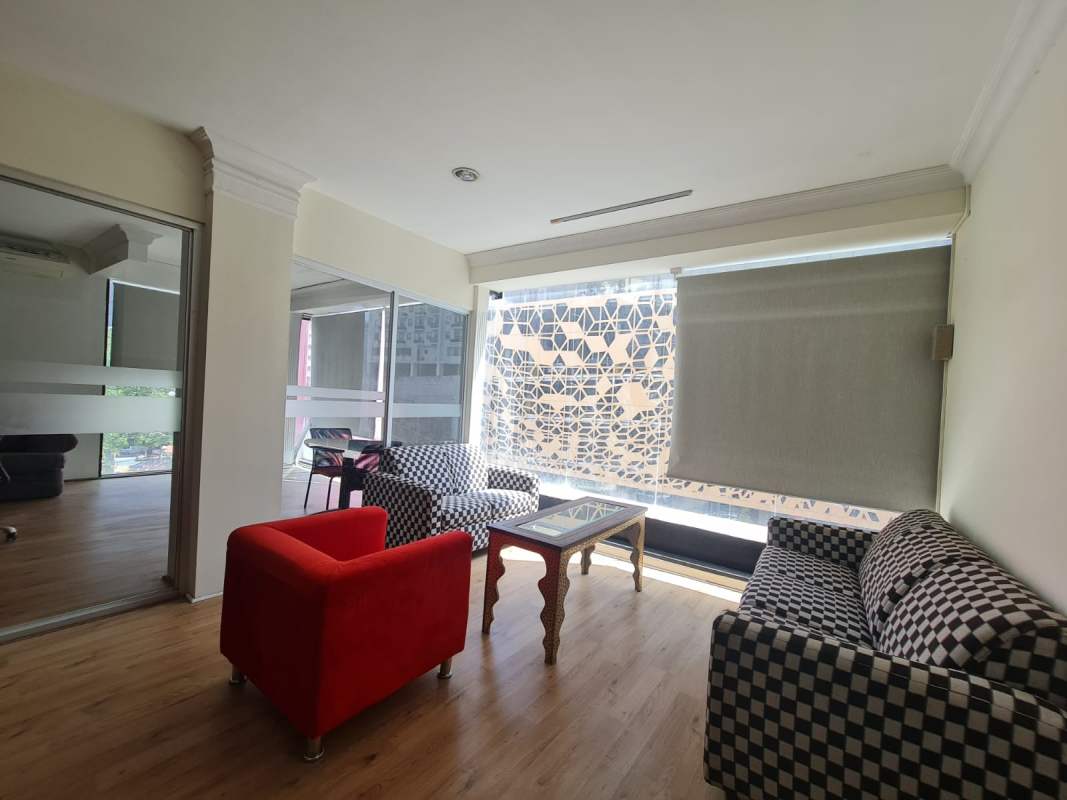 Bathroom with decorative tiles, pedestal sink, toilet inside commercial office Obarrio Center Panama