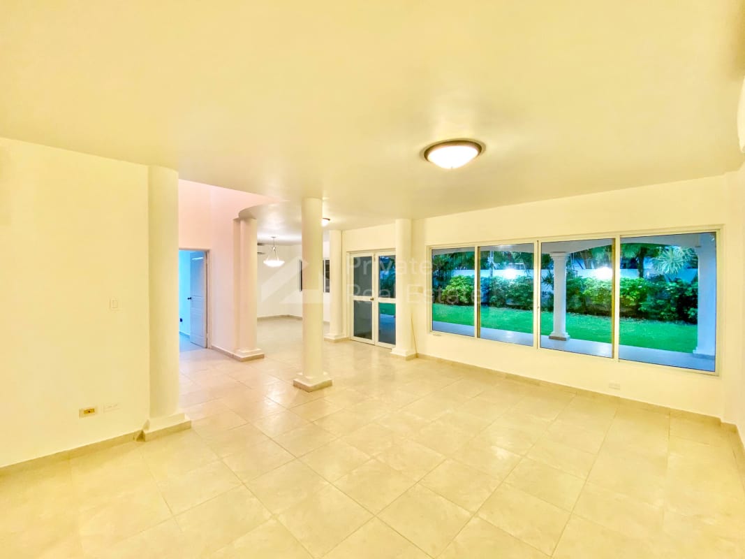 Dining area luxury rental house Costa Serena Costa del Este large windows garden view