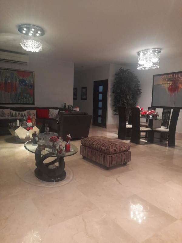 Open plan living and dining room with marble floors and stylish lighting in El Carmen Panama