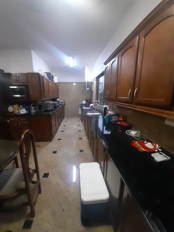 Spacious covered terrace overlooking lush garden in El Carmen house Panama