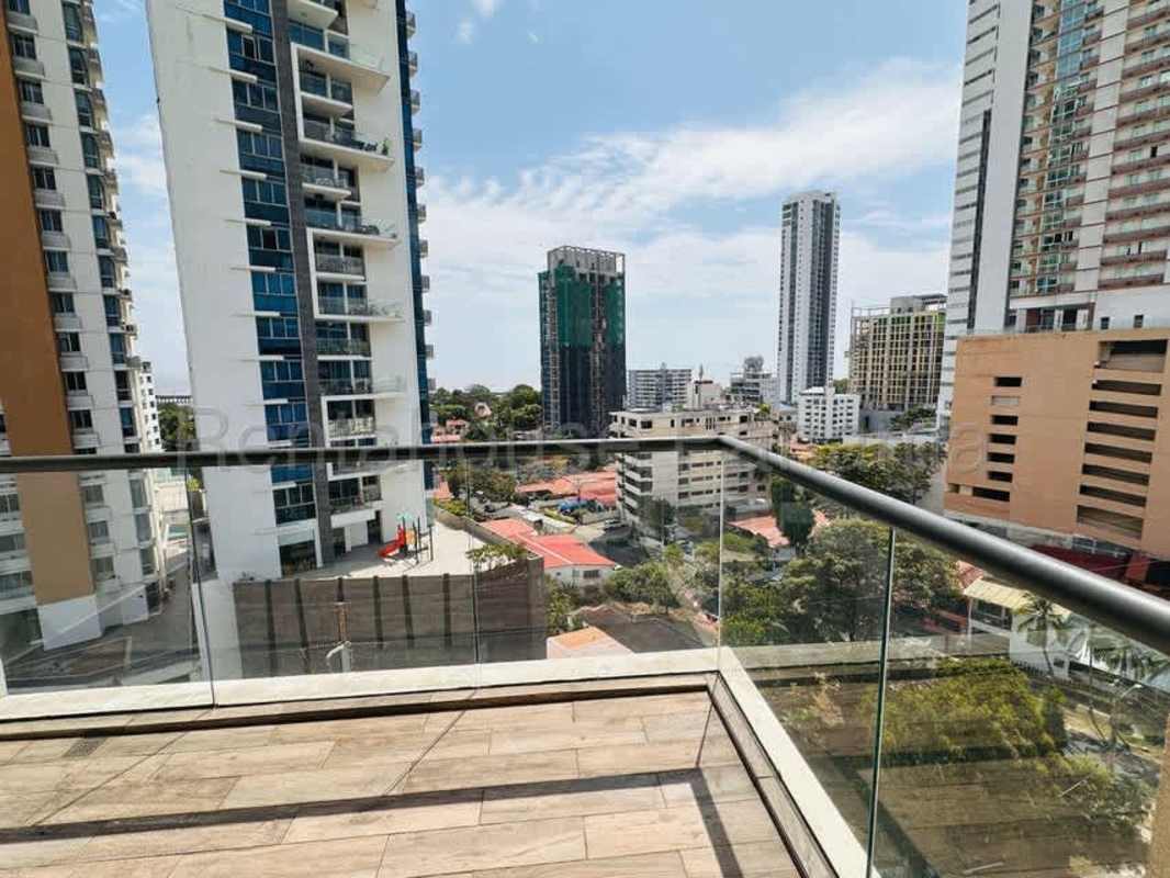 Private balcony with glass railing and views of ocean and city at PH Coco del Mar Panama