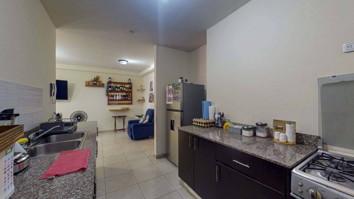 Equipped kitchen with granite counters, appliances and open shelving PH El Doral Panama City