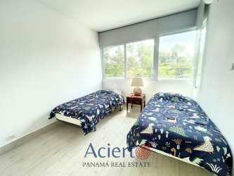 Minimalist guest bedroom with two beds in PH Solea Punta Barco beach condo Panama