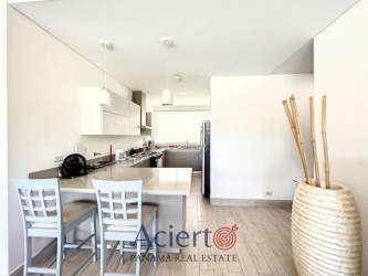 Modern open kitchen with breakfast bar and dining area Punta Barco Panama beachfront condo