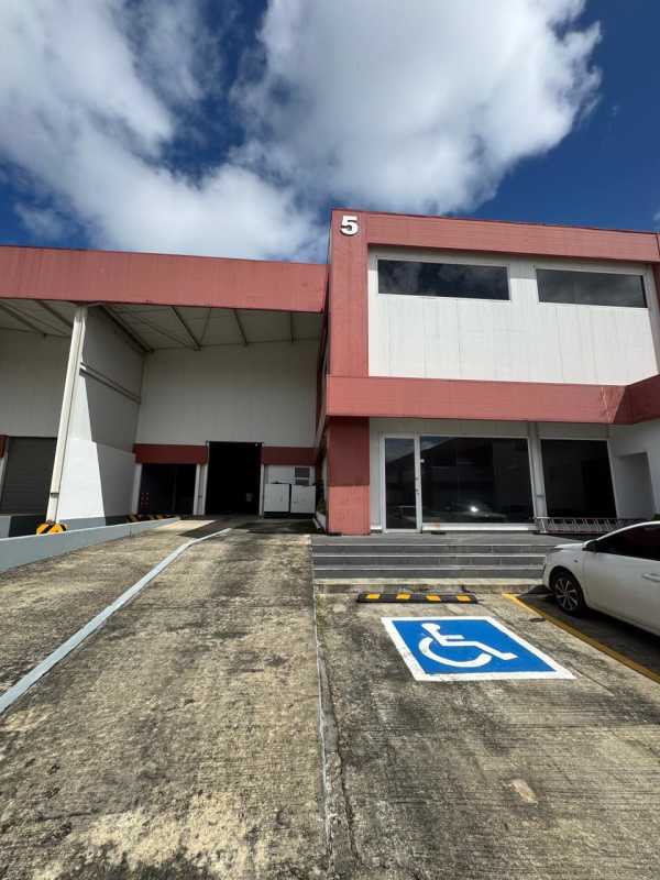 Facade of warehouse unit 5 with loading dock, ramp access, and parking at PH Las Americas