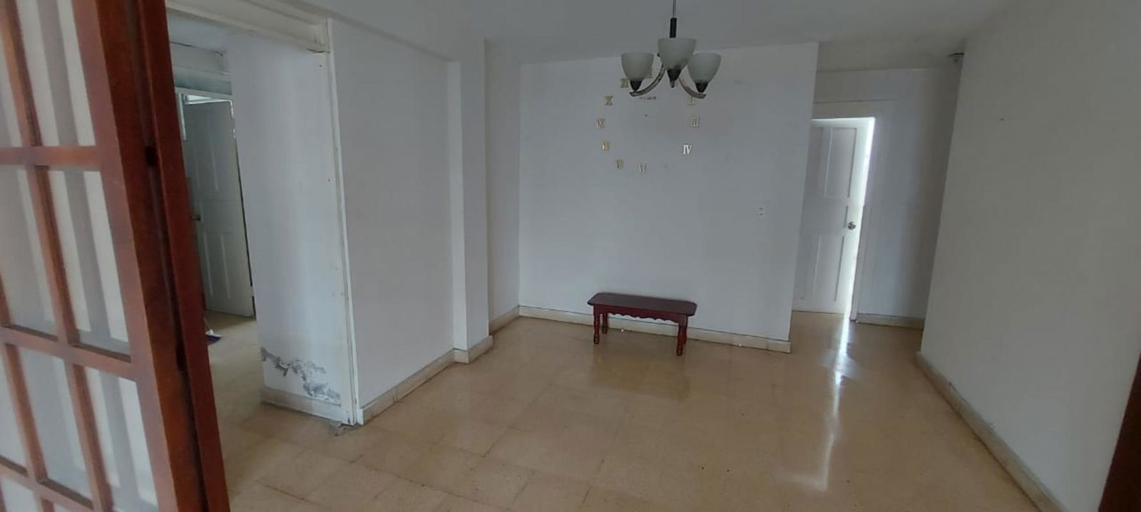 Open layout living room with beige tiles and partition wall in El Ingenio Panama