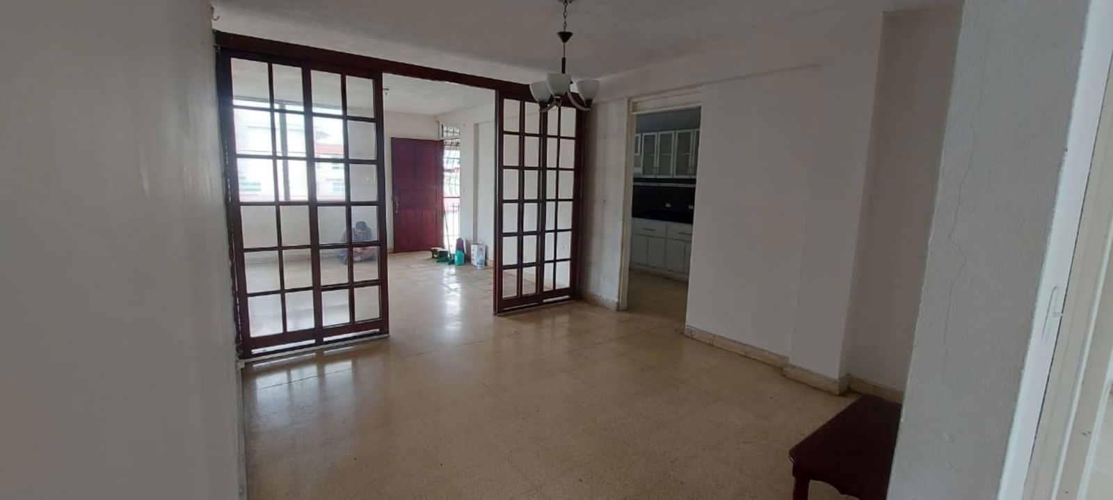 Large empty living space with ceramic flooring in El Ingenio apartment Panama