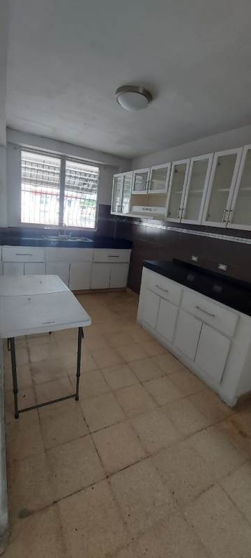 Bedroom with large jalousie windows and built-in closet in El Ingenio apartment Panama