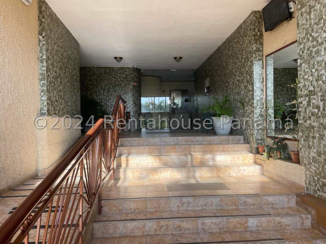 Bright open living dining area with tile flooring and ceiling fans in Betania apartment with terrace.